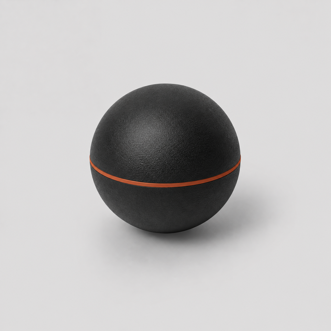 Balle de massage myofasciale Shapebox noire avec liseré cuivre, fond studio gris clair
